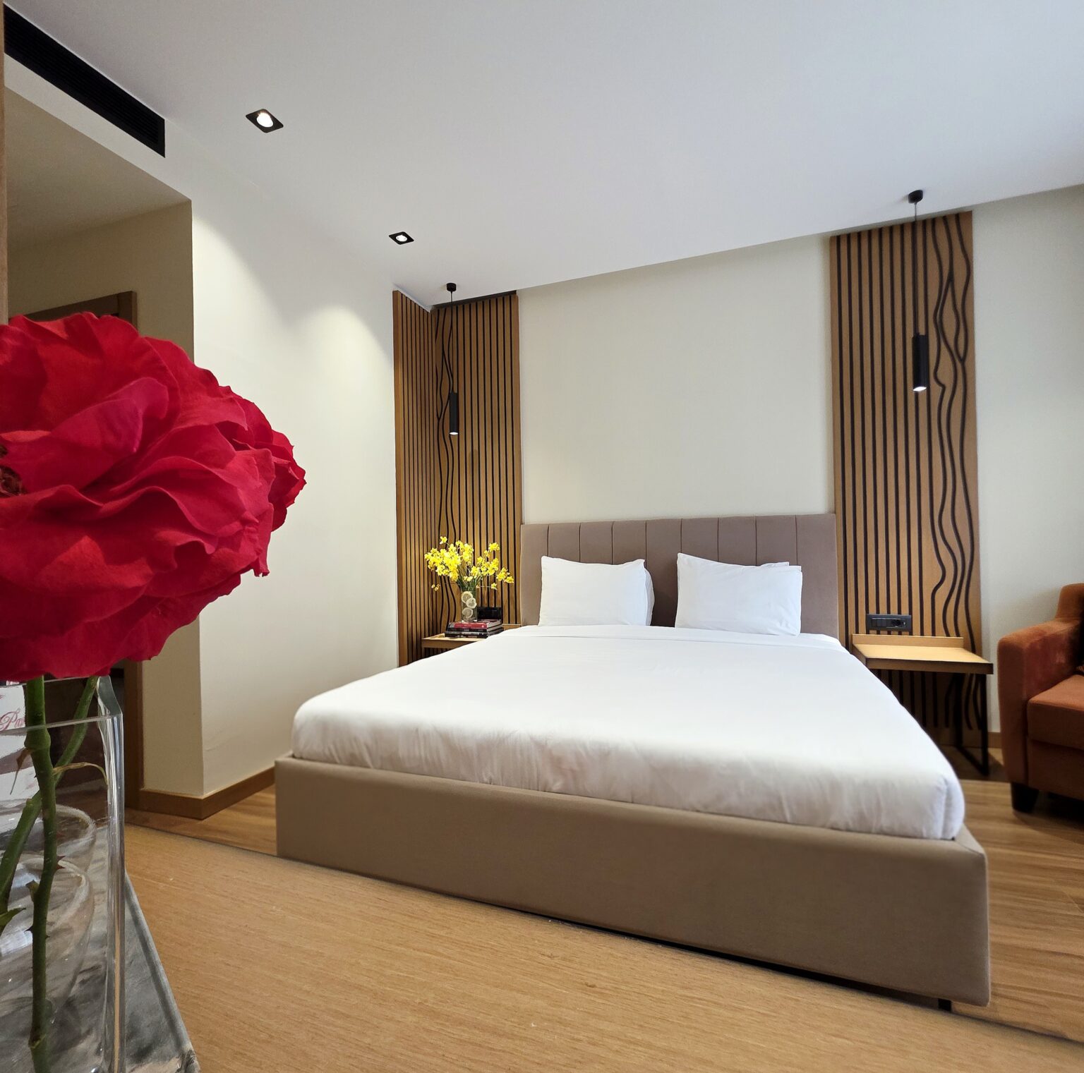 Double Superior room with king-size bed and a large red rose in the foreground