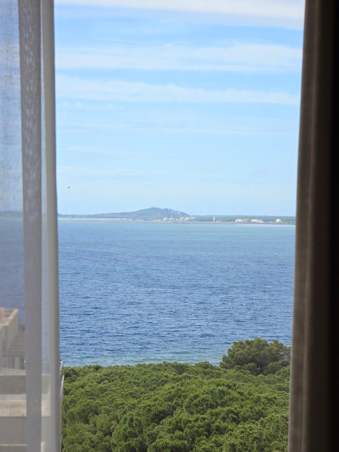 Sea view from the Twin Deluxe Room window across the Bay of Vlorë towards a low headland
