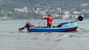 A fisherman in the bay of Vlora, showing also the sea.
