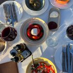 EdenRooftopRestaurant-Valza-10 Shared table from above with burrata and tomatoes, meatballs, chips, pepper salad, red wine and an Eden menu